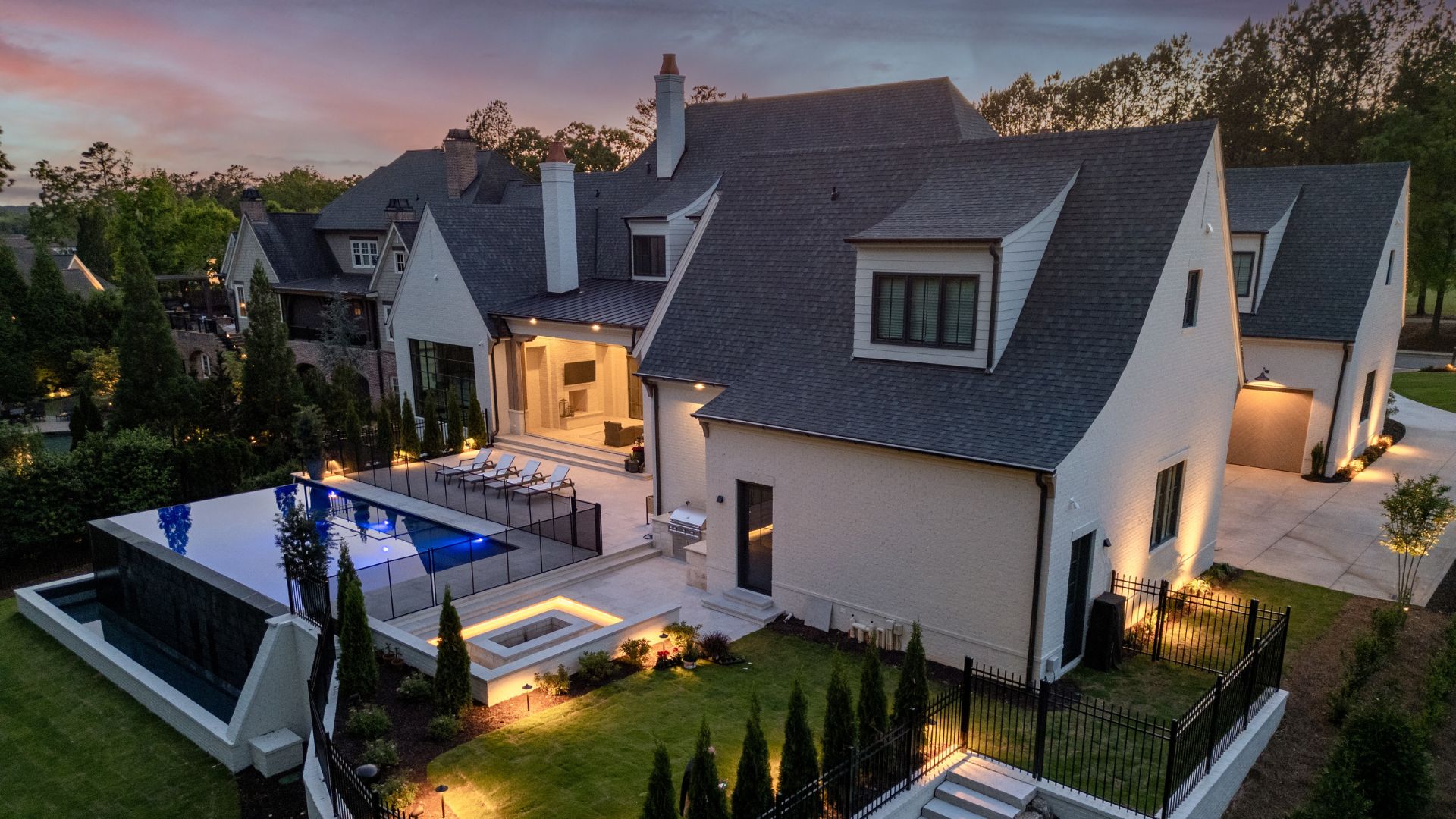 aerial lighted view of home and pool