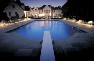 beautiful pool with outdoor lighting