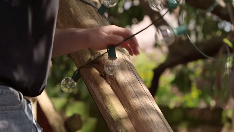 Person Installing String Lights