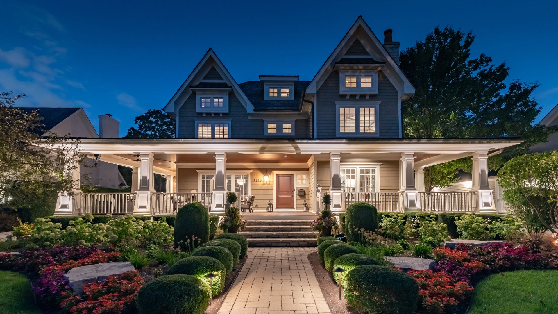 A house with a walkway and bushes