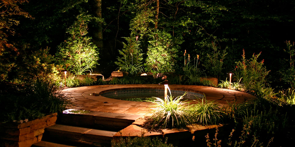Outdoor hot tub with landscape lighting
