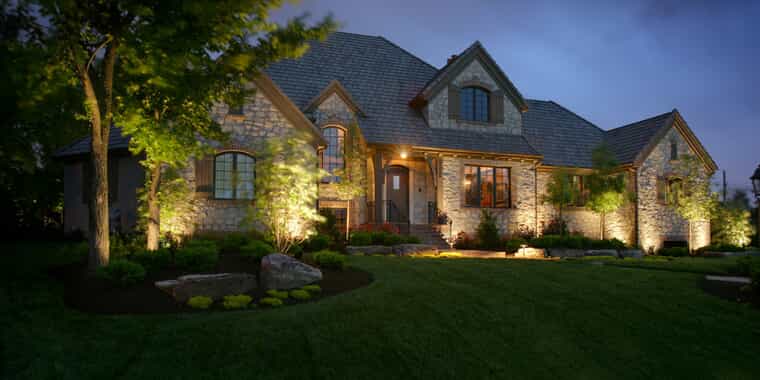 Home and front yard with landscape lighting