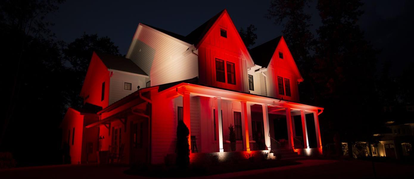 Outside of white home with color changing red lights