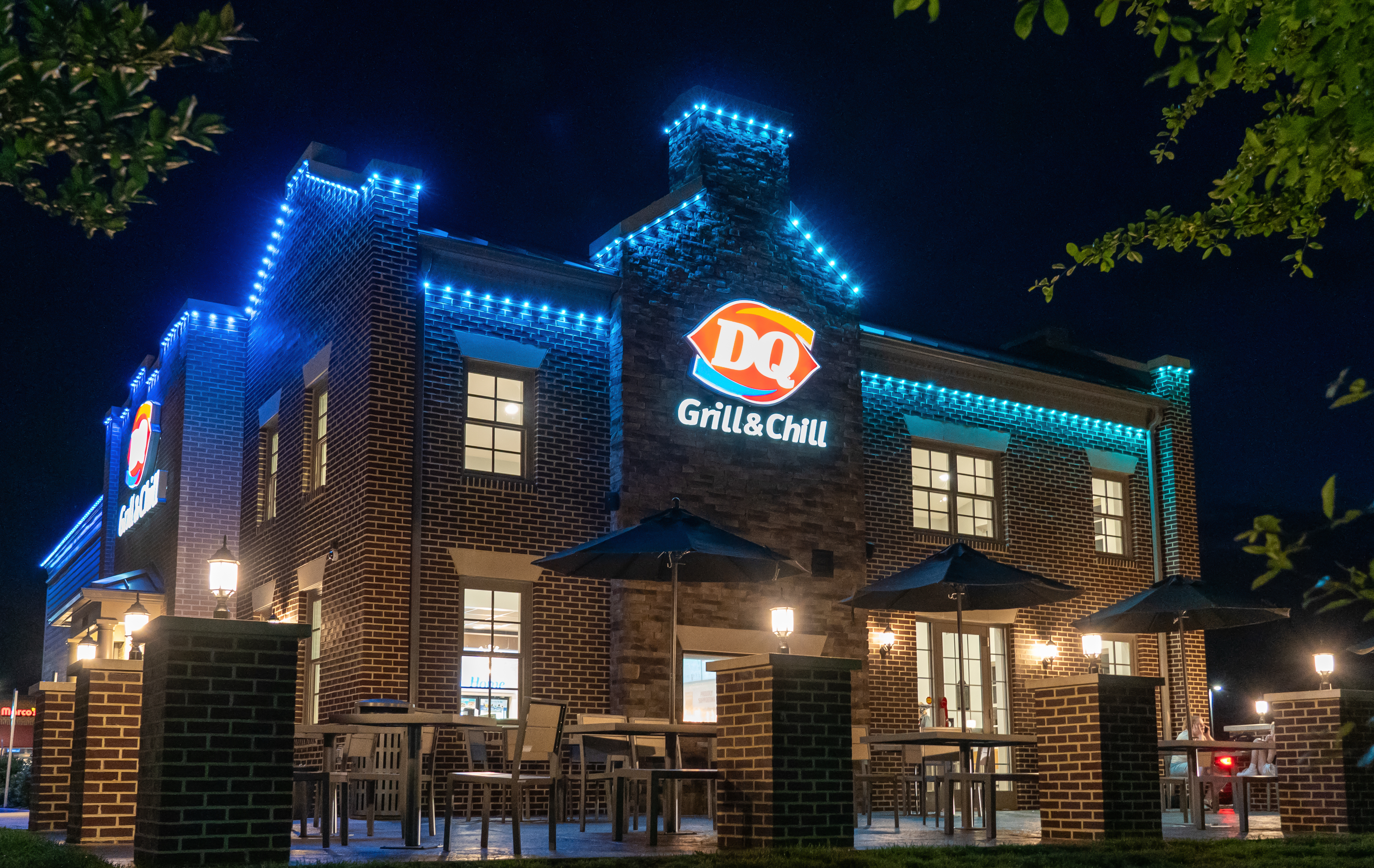 Dairy Queen restaurant with permanent roofline lighting set to a bright blue color