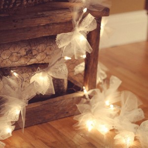 squares of tulle fabric tied onto string lights
