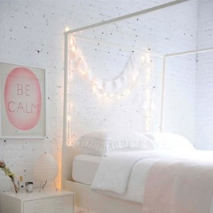 using string lights to add interest to white bedroom walls