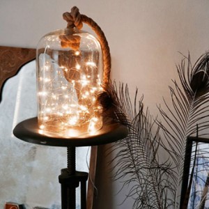 a lamp of string lights stuffed into a glass container