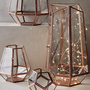 a lamp of string lights stuffed into a geometric container