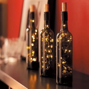 a lamp of string lights stuffed into a wine bottle