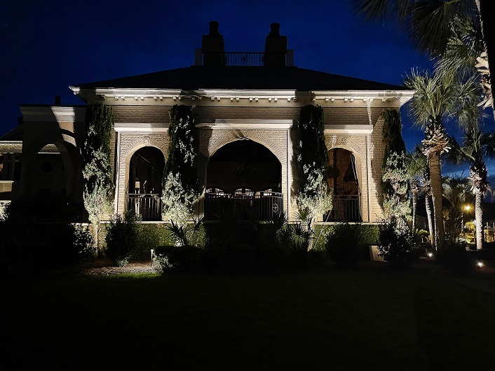 structure with outdoor lighting and trees